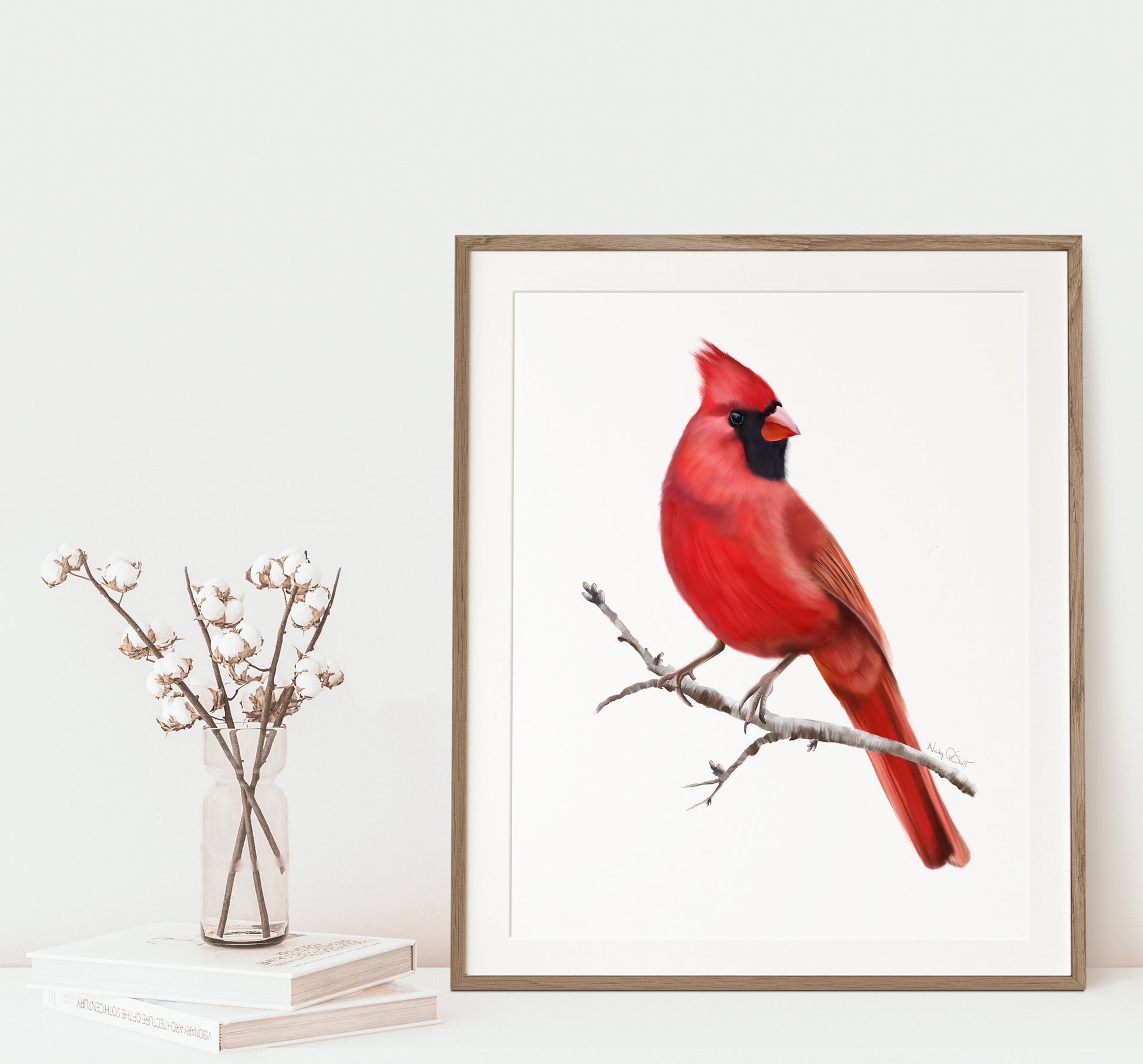 Framed artwork of a red cardinal bird on a branch with a minimal background