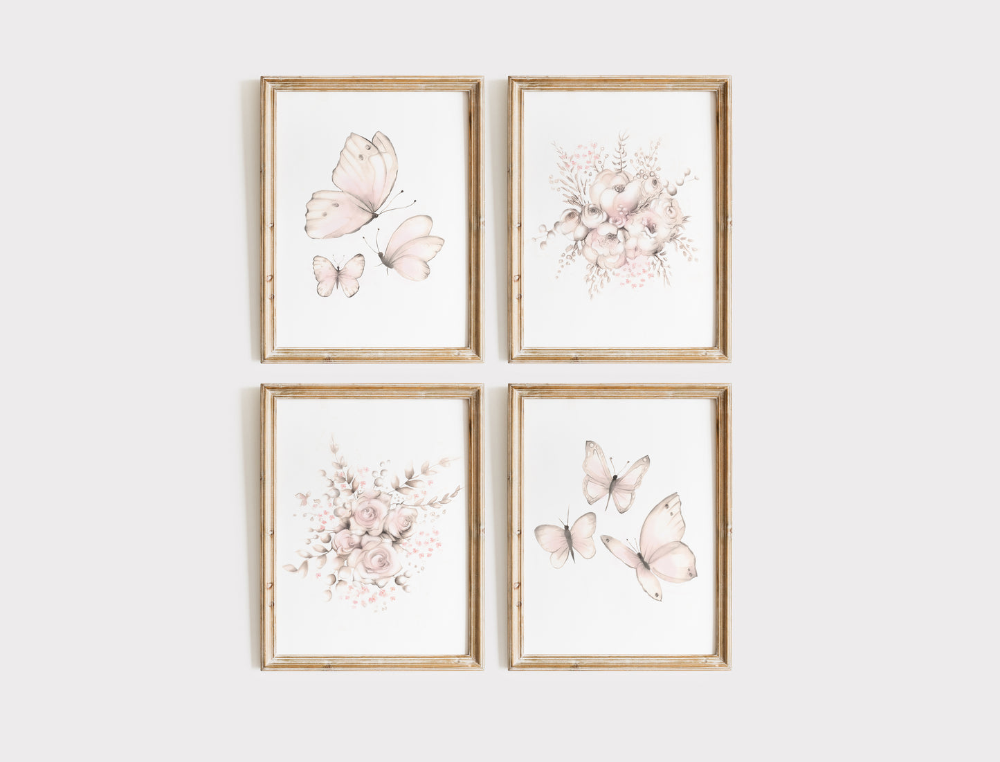 Four framed prints with blush pink floral and butterfly designs on a white wall.