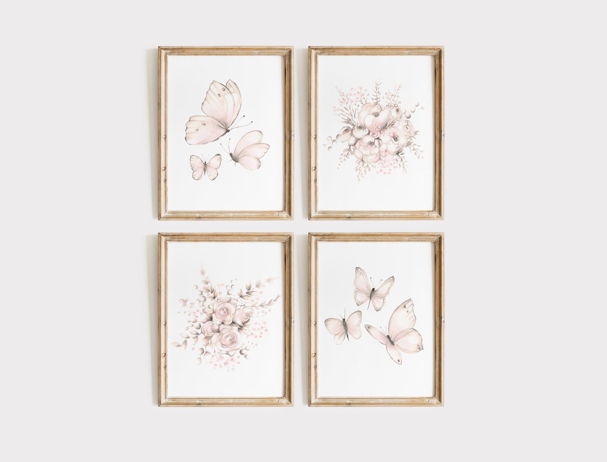 Four framed prints with blush pink floral and butterfly designs on a white wall.